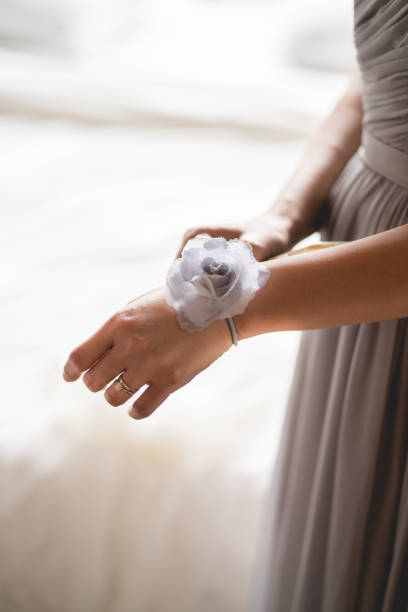 Bridegroom wearing a flower on her hand stock photo