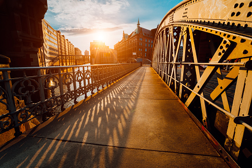 Bridge Arch with rivets in the Speicherstadt of Hamburg during sunset golden hour with sunset light