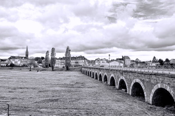 Bridge in the City of Sedan in France View on old houses and bridge in city of Sedan. France in rainy day. Black and White Picture aquitaine photos stock pictures, royalty-free photos & images