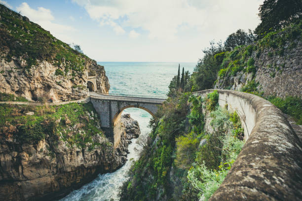 bridge over the fjord of furore, amalfi coast, italy famous bridge of furore at the amalfi coastline in italy. amalfi coast stock pictures, royalty-free photos & images