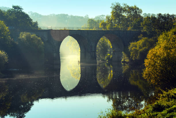 Bridge over the  Orne River, Normandy,  France Landscape with a bridge with arches  reflected in  the Orne River , located in the Calvados department in Normandy. calvados stock pictures, royalty-free photos & images