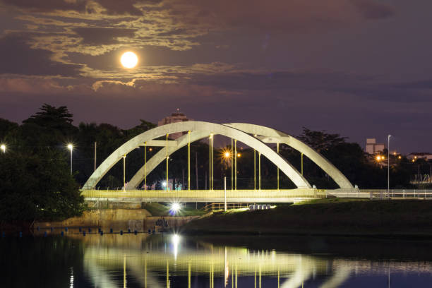 Bridge over the Rio Preto at dawn with the super full moon lighting the sky - São José do Rio Preto, Sao Paulo, Brazil stock photo