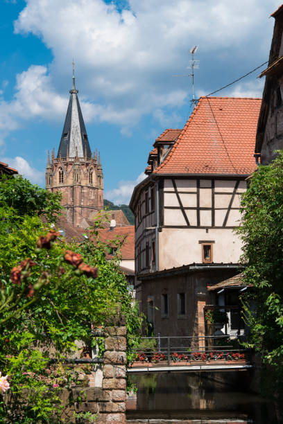 bridge with view on canal, half timbered houses and St Pierre and St Paul church. Wissembourg, France Canal, tower, church and traditional house in Wissembourg, France bas rhin stock pictures, royalty-free photos & images