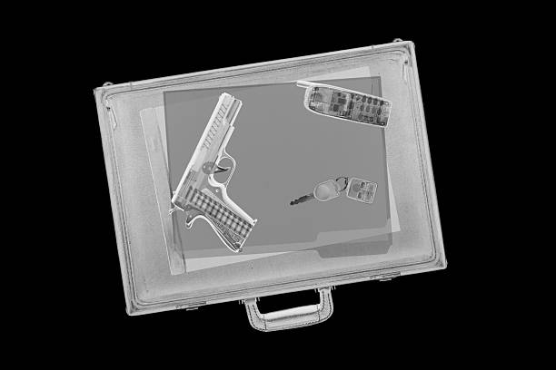 Briefcase with Gun XXL. Airport x-ray image of a briefcase with a handgun inside. gchutka stock pictures, royalty-free photos & images
