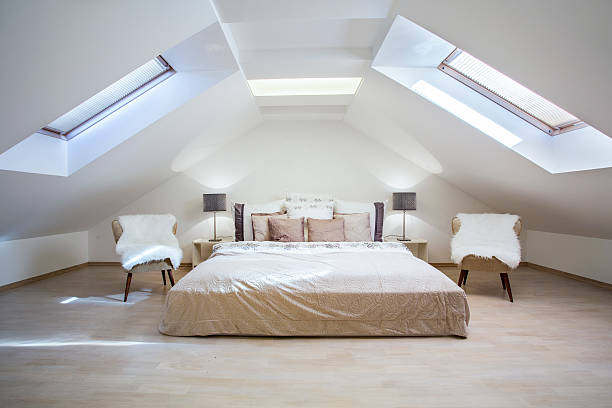 Bright attic bedroom in the apartment Bright attic bedroom in the fashionable apartment loft apartment stock pictures, royalty-free photos & images