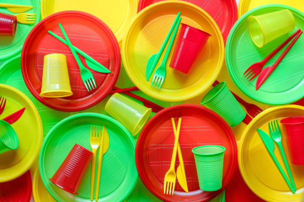 Bright plastic disposable tableware background Bright plastic disposable tableware background disposable stock pictures, royalty-free photos & images