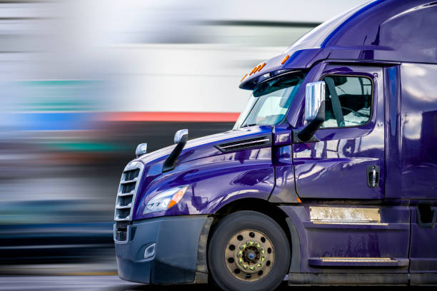 Bright Purple Bonnet Semi Truck Tractor with Reflection Driving on the Road for Delivery Commercial Cargo Bright Purple Bonnet Big rig long haul diesel Semi Truck with high cab configuration for improve aerodynamics transporting Commercial Cargo Driving on the Road for Delivery"n semi truck side view stock pictures, royalty-free photos & images