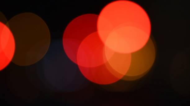 Bright red and orange colors bokeh lights in night darkness stock photo
