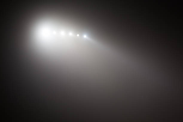 Bright white and yellow Stadium lights with fog. Defocused image stock photo