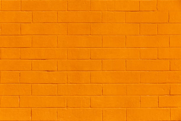 Bright yellow brick wall background for text and design stock photo