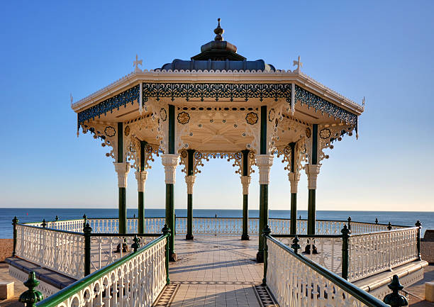 Brighton & Hove Bandstand Brighton & Hove's historic Victorian seafront bandstand. After years of neglect it re-opened in summer 2009, having undergone a major restoration project to return the building to its Victorian splendour. In the summer it is regularly used for public concerts and entertainment. The photo has already been lens corrected to remove distortion english channel photos stock pictures, royalty-free photos & images