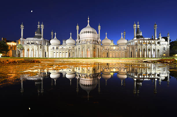 Brighton Pavilion moonlight "The Brighton Pavilion by (with) Moonlight and floodlight reflected in an ornamental pondStraight time exposure photograph - no image manipulationThe Royal Pavilion is a former royal residence (now a public building) located in Brighton, England. It was built in three stages, beginning in 1787, as a seaside retreat for George, Prince of Wales, from 1811 Prince Regent. It is often referred to as the Brighton Pavilion." brighton stock pictures, royalty-free photos & images