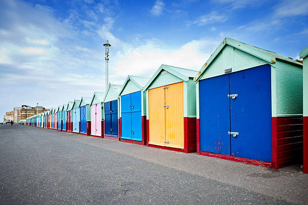 British Beach Huts A row of beach huts on the southern English coastline, Brighton. brighton stock pictures, royalty-free photos & images