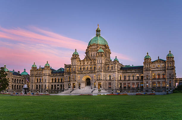 British Columbia Provincial Parliament at Sunset Photo of the exterior of the British Columbia Parliament Buildings at Sunset. The neo-baroque buildings and the front lawn face Inner Harbour in Downtown Victoria, Canada. british columbia stock pictures, royalty-free photos & images