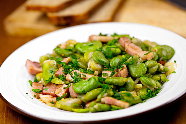 Broad bean with bacon "Broad bean with bacon, onion and parsley" broad bean stock pictures, royalty-free photos & images