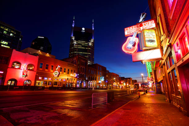 Broadway in downtown Nashville, Tennessee Nashville, Tennessee, USA - March 30, 2016: Music venues and Honky Tonks on Broadway which is the renowned entertainment district for country music broadway nashville stock pictures, royalty-free photos & images
