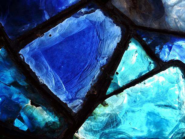 broken blue stained-glass window. Close up of broken blue stained-glass window. linkage effect stock pictures, royalty-free photos & images