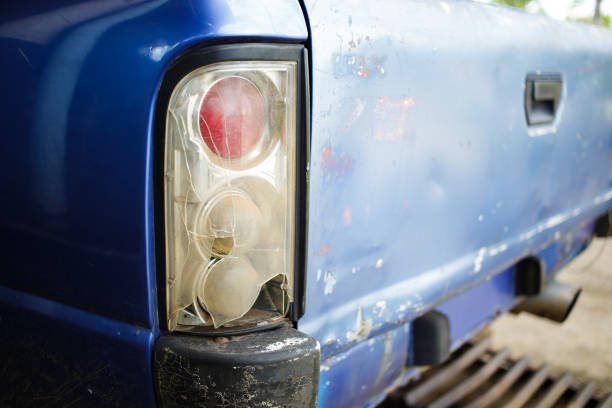 broken car tail light on blue pickup truck stock photo