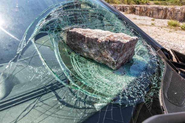 Broken car windshield broken car windshield with a huge stone vandalism stock pictures, royalty-free photos & images