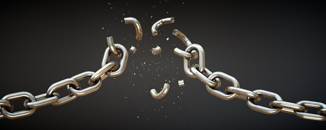 This scene shows a chain falling apart under strain of force. The chains central links are breaking apart and many small fragments are blowing vertically out. The scene is isolated on a dark patterned background.