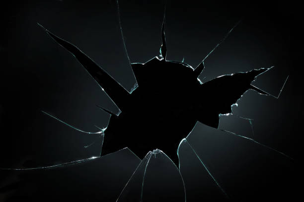 broken cracked glass with hole in black background broken cracked glass with hole in black background broken stock pictures, royalty-free photos & images