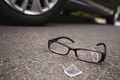 Close-up of broken glasses near the car