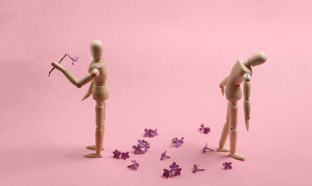 Broken heart. Two puppets on a pink background. Parting, attitude stock photo
