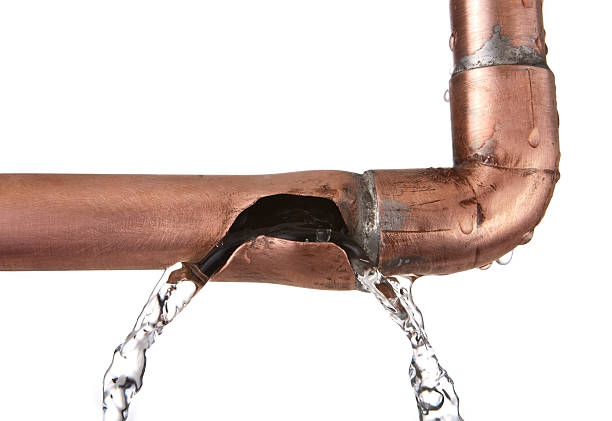 broken leaking copper water pipe stock photo