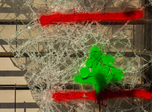 Broken window glass with the Lebanese flag drawn on it Beirut Lebanon 11/23/2019 A demolished downtown shopping window with a drawing of the Lebanese national flag on the remains in downtown Beirut Lebanon Flag stock pictures, royalty-free photos & images