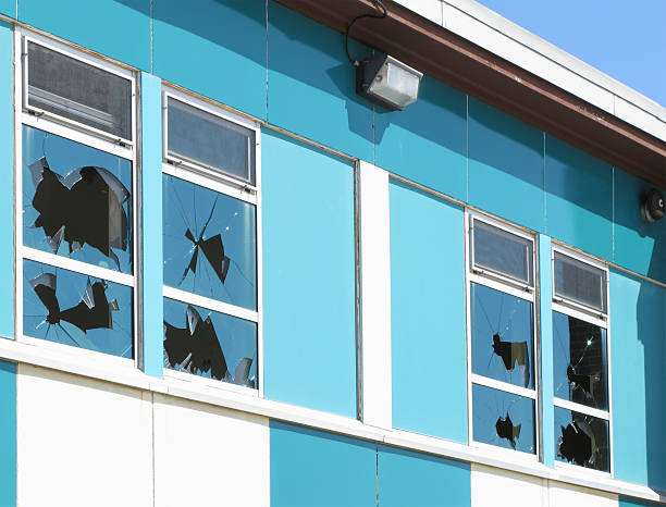 Broken windows. Broken windows in an abandoned and vandalised school. vandalism stock pictures, royalty-free photos & images