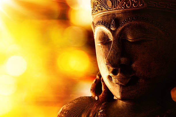 bronze buddha statue oriental culture -  golden Buddha with blurred light buddha stock pictures, royalty-free photos & images