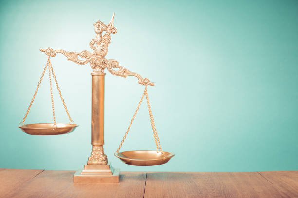 Bronze law scales on table. Symbol of justice. Retro old style filtered photo stock photo