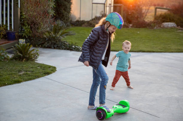 Brother and Sister Hoverboard stock photo
