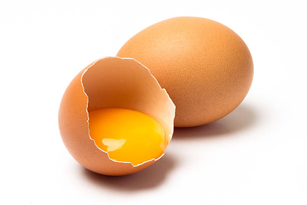 Brown eggs Two brown chicken eggs isolated on white background egg yolk photos stock pictures, royalty-free photos & images