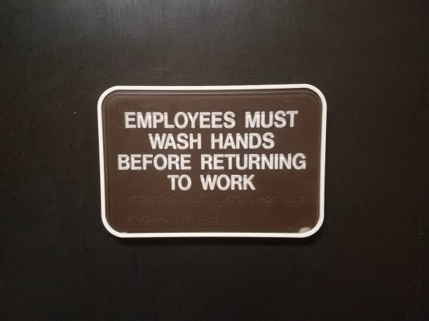 brown employees must wash hands before returning to work sign on door stock photo