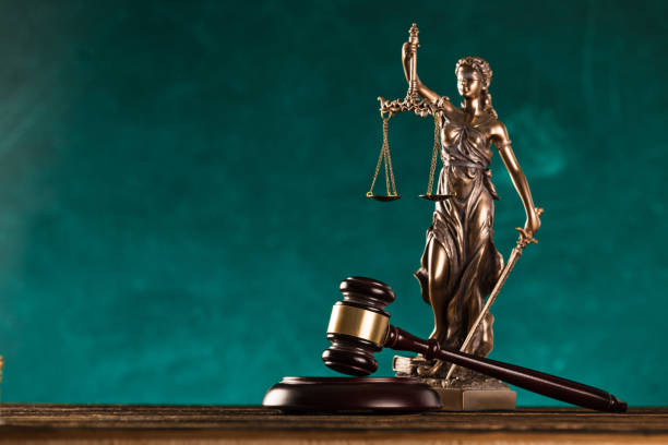brown gavel with statue of justice. stock photo