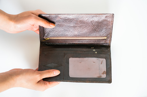 Brown leather wallet; payment gesture
