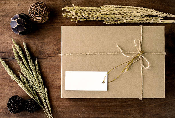 Brown paper box on old wood background with dried flower, Vintage tone