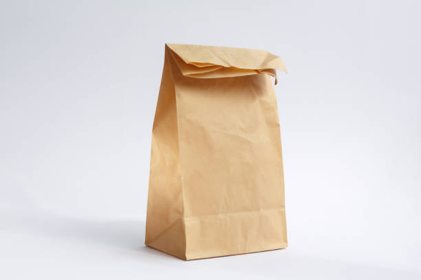 brown paper craft bag on a white background - paper bag craft imagens e fotografias de stock