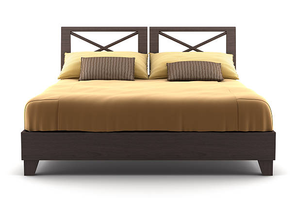 Brown wooden bed with tan sheets on a wooden surface brown wooden bed isolated on white background bed furniture stock pictures, royalty-free photos & images