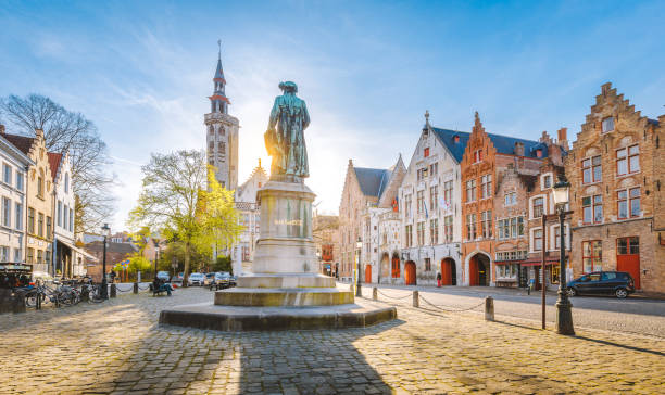 Brugge city center at sunset, Flanders region, Belgium Scenic view of historical Brugge city center with famous Jan van Eyck square in beautiful golden evening light, Flanders region, Belgium brugge belgium stock pictures, royalty-free photos & images
