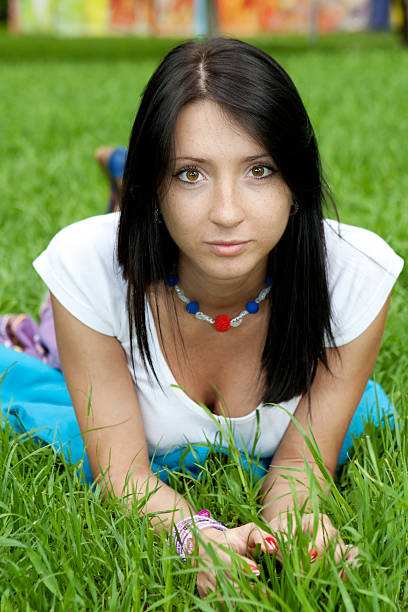 brunette woman in park stock photo
