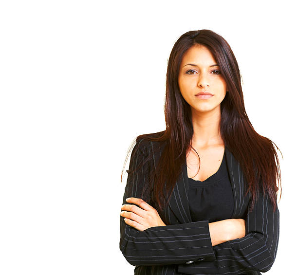 Brunette woman wearing black suit jacket with arms crossed stock photo