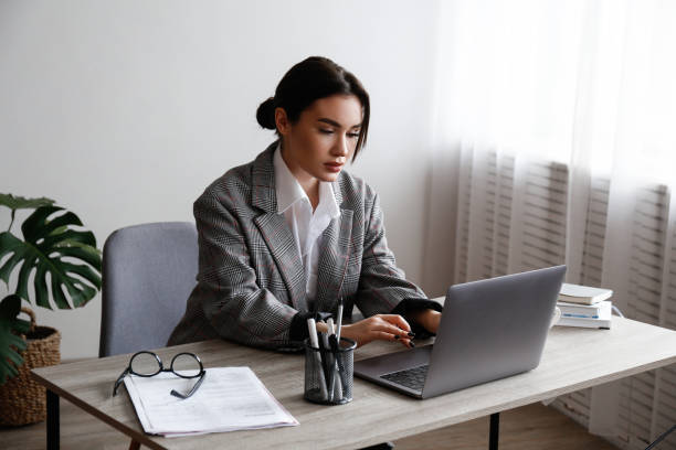 Brunette woman with laptop stock photo
