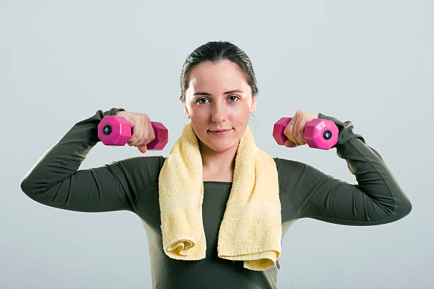 Brunette working out with weights stock photo