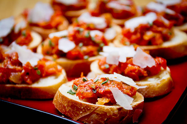 Bruschetta Bruschetta with minced tomato, garlic, olive oil and shaved parmesan cheese canape photos stock pictures, royalty-free photos & images