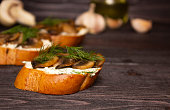 Bruschetta with mushrooms. Sandwiches with soft cheese, mushrooms and dill. Side view, close up. Healthy delicious Breakfast, Italian cuisine.