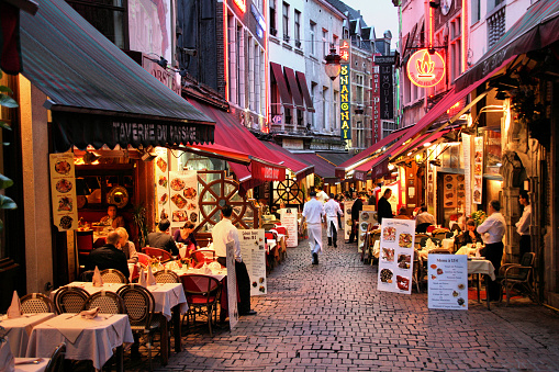 Evening view of restaurants in Brussels, Belgium. Rue des Bouchers street is famous for its numerous restaurants offering cuisine from any place in the world.