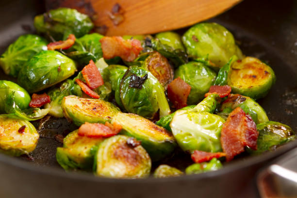 Brussels sprouts cooking in a skillet stock photo