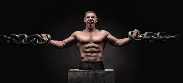 Brutal man bodybuilder athlete holding a chain stock photo